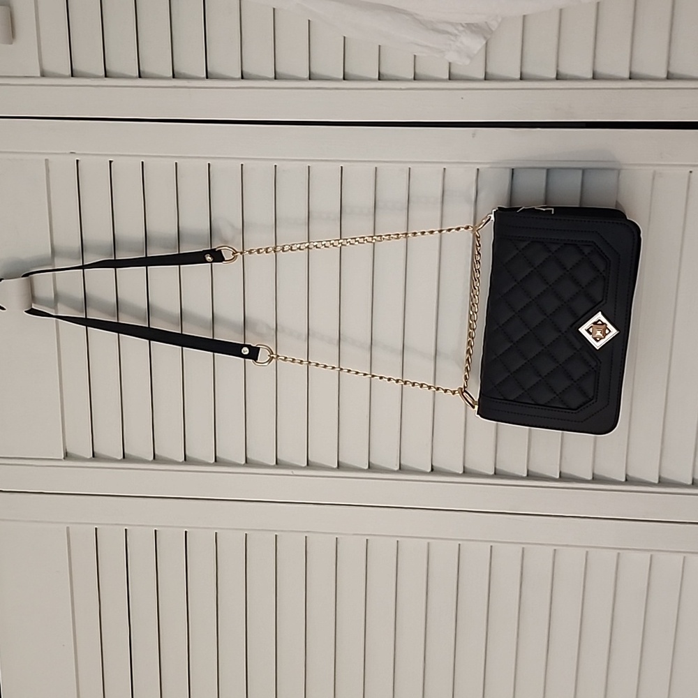 Black quilted shoulder bag with adjustable strap. Gold hardwear. Unknown name
